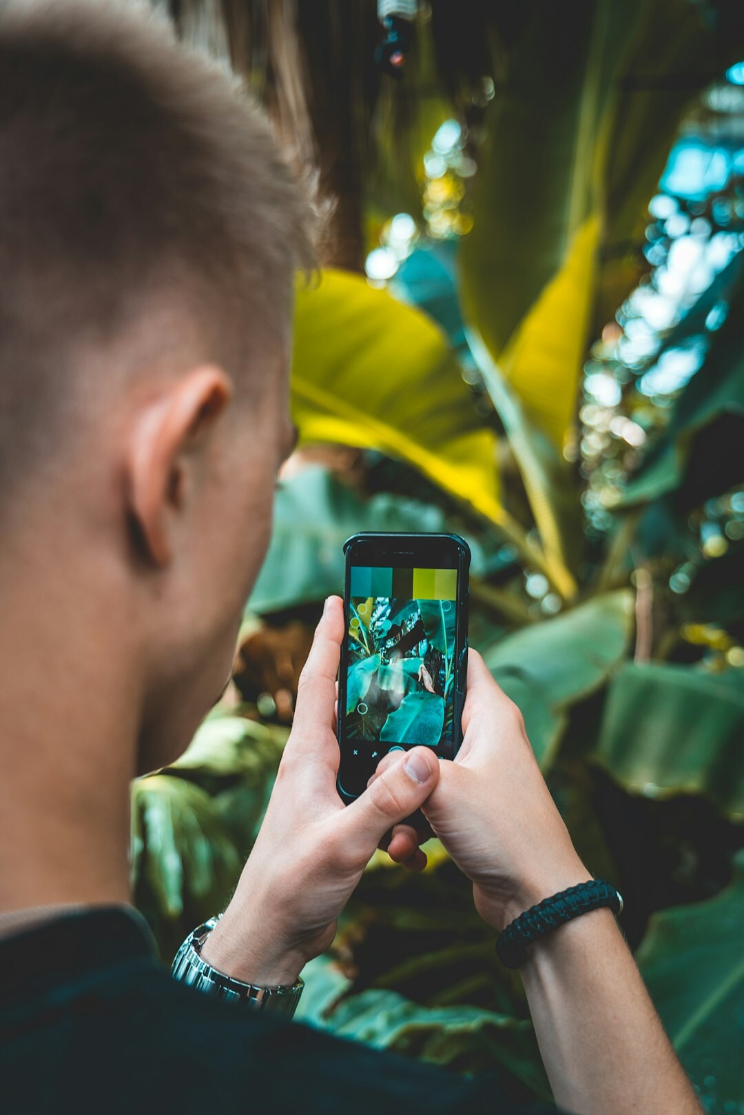 Danish male photographer holding a camera outdoors