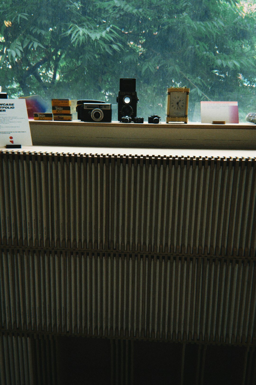 Camera, lenses and notebook on a wooden desk