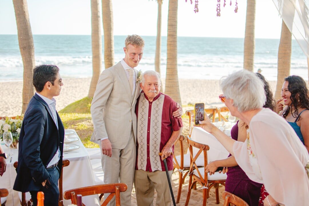 Wedding guests laughing at an outdoor reception
